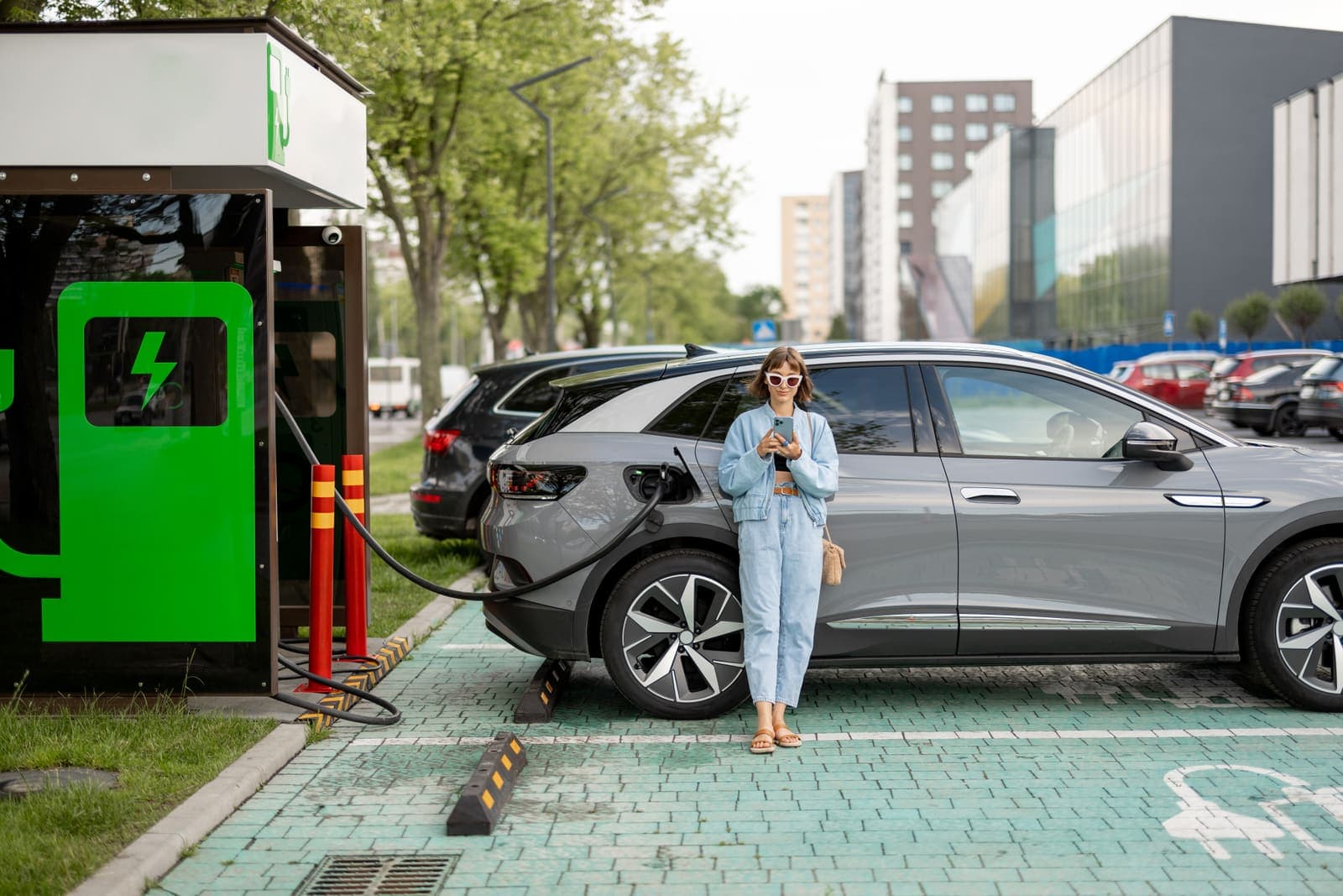 Driver at a public fast charger in the city